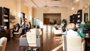 Modern interior of a hair salon San Diego showcasing professional hairstylists, natural lighting, and eco-friendly products.